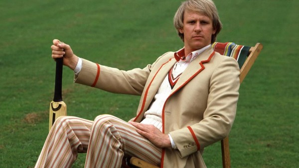Peter Davison as the Fifth Doctor. seated and holding a cricket bat