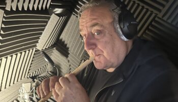 Michael Troughton playing the recorder in sound booth
