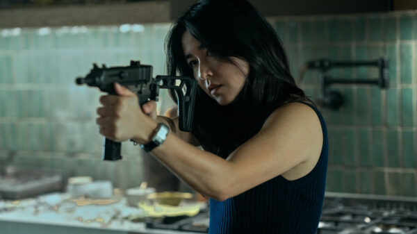 Maya Erskine aiming a gun