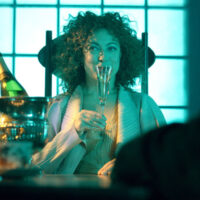 Alex Kingston as River Song, raising a champagne glass