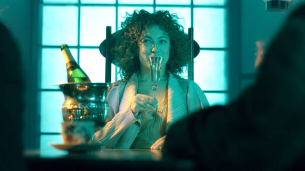 Alex Kingston as River Song, raising a champagne glass