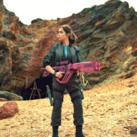 Black Mirror season 7 - Cristin Milioti holding an enourmous pink futursitic blaster