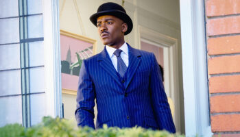 Ncuti Gatwa as the Doctor, wearing a pinstripe suit and bowler hat, in Doctor Who The Reality War