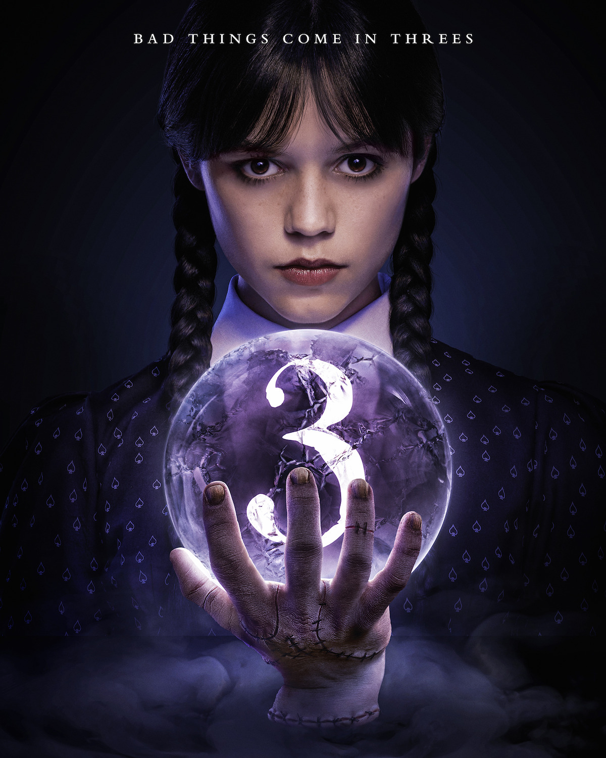 Wednesday season 3 announcement poster - Wendnesday behind a crystal ball, held by Thing, with a number 3 inside.