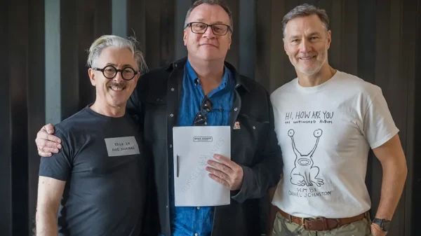 Russel T Davies holds a script for Tip Toe and stands in the middle with Alan Cummings on his left and David Morrissey on his right