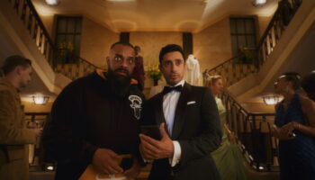 Bait First look image with Guz Khan on the left in a casual outfit and Riz Ahmed on the right in a tuxedo