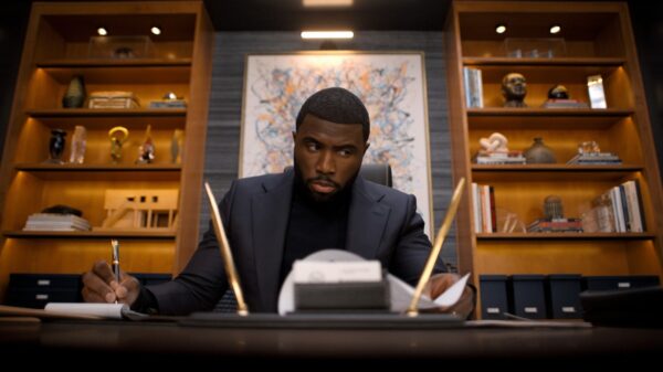 Y’lan Noel sat at an ornate desk as his character in Nemesis, Netflix's new crime drama