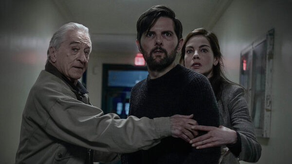 Robert De Niro, Michelle Monaghan and Adam Scott, huddling in a hallway. All cast in The Whisper Man