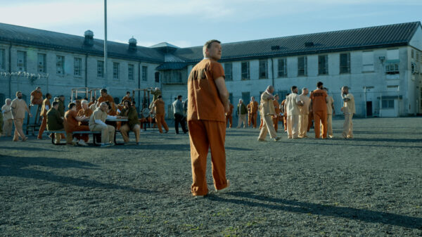 A still of the protagonist in a prison yard in I Will Find You