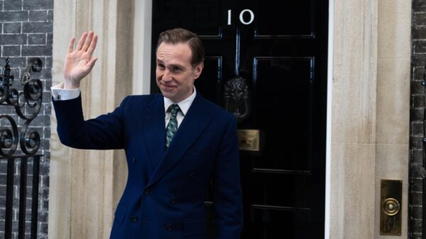 A fictional prime minister stands outside Number 10