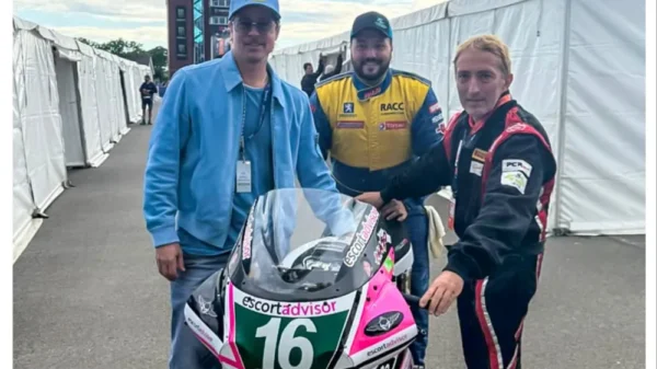 Brad Pitt stood next to two Isle of Man motorcyclists