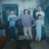 A family huddles against a mysterious light in their living room in The Last House