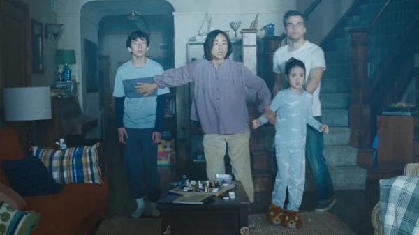 A family huddles against a mysterious light in their living room in The Last House