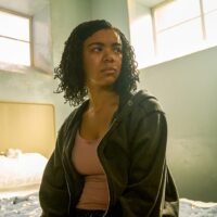 A woman on a bed in a still from The Rapture